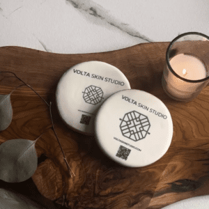 Two white plates sitting on top of a wooden board.